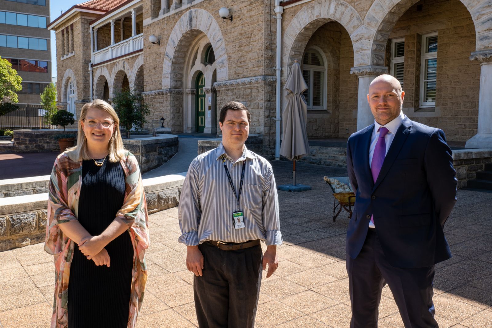 (from left to right) Kristen Potter, Group Manager Organisational and Cultural Development; Joshua Ford, Records Assistant; and Nick Foster, General Counsel are standing outside The Perth Mint office and looking at the camera.