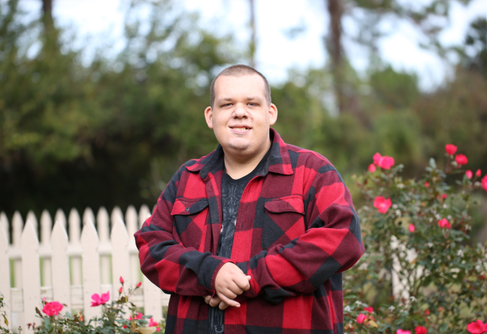 A man standing in a garden and smiling at the camera (used for representation purposes only).