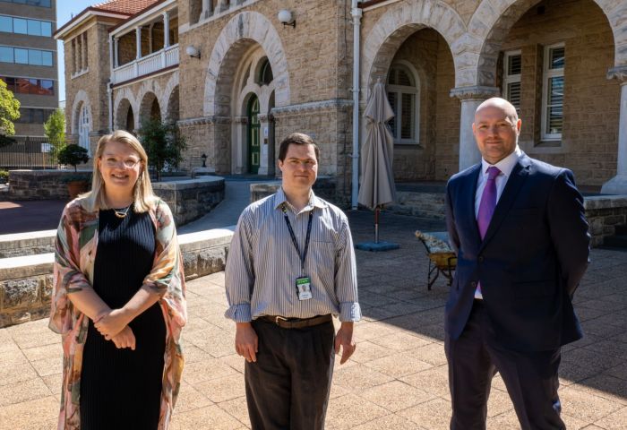 (from left to right) Kristen Potter, Group Manager Organisational and Cultural Development; Joshua Ford, Records Assistant; and Nick Foster, General Counsel are standing outside The Perth Mint office and looking at the camera.