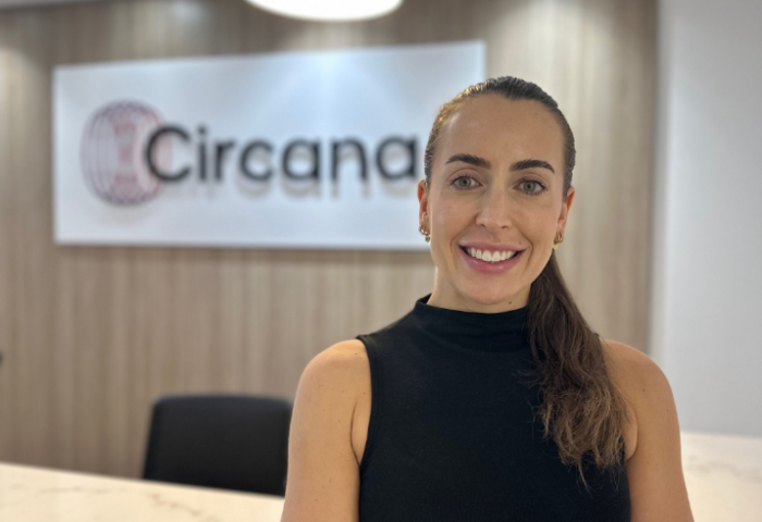 Jessica smiling at the camera with Circana logo in the background