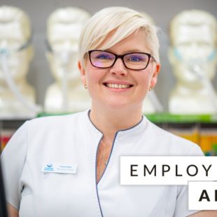 lady smiling behind Employ their Ability slogan