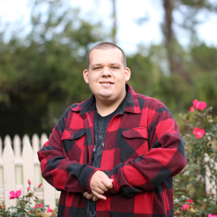 A man standing in a garden and smiling at the camera (used for representation purposes only).