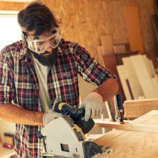 A carpenter doing his job in a carpentry workshop.