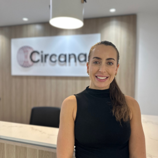 Jessica smiling at the camera with Circana logo in the background