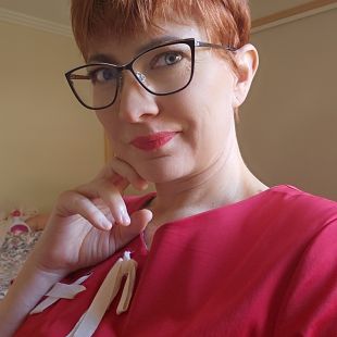 photo of Tegan in a red shirt and glasses.